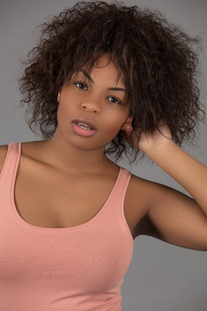 A studio image of a beautiful young black model shot against a plain backgroundの写真素材