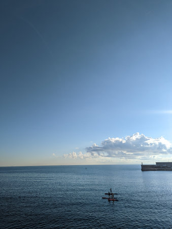 Paddleboarders head out to sea.の写真素材