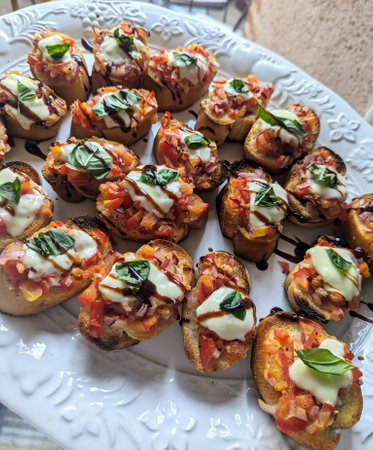 Bruschetta with tomato, mozzarella cheese and basilの写真素材