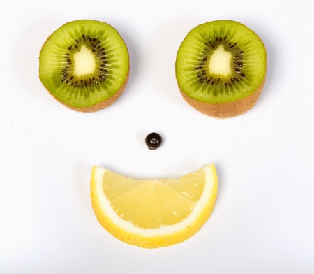 Intersected kiwies and lemon with blueberry aranged like happy smileの写真素材