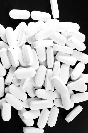 Many white pills isolated on blackの写真素材