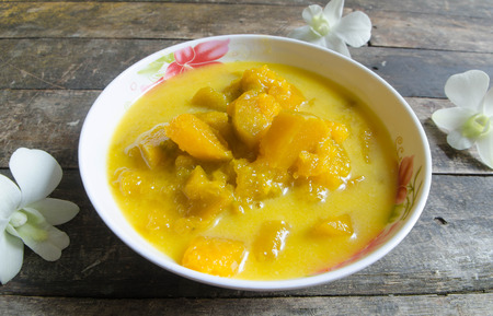 pumpkin in coconut milk on the wooden background.Thai Dessert.の写真素材