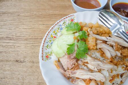 thai food gourmet fried chicken with rice, khao man kai tod crispy pork in wood background.の写真素材