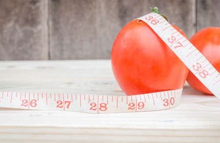 ripe tomatoes on wood background.の写真素材