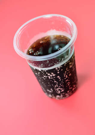 cold brown drink in plastic glassの写真素材
