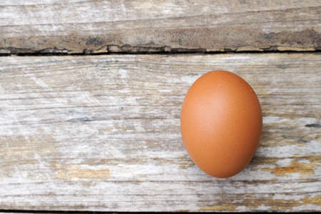 Farm fresh eggs isolated on wooden table.の写真素材