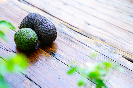 Fresh green avocado on a wooden table is a very useful and vitamin fruit.