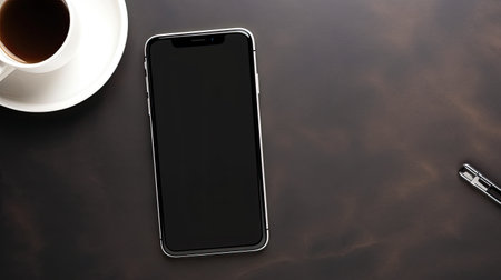 Smartphone with blank screen and coffee cup on brown background, top viewの素材