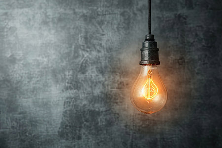 Vintage light bulb on grunge wall background with copy spaceの素材