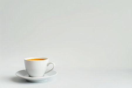 A simple, elegant coffee cup filled with black coffee, against a blank background, emphasizing minimalism and serenityの素材