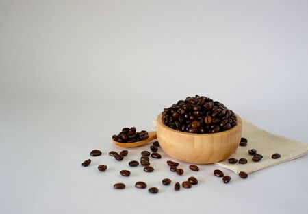 Roasted coffee beans on a white surface, top view with spaces designed for you.の写真素材