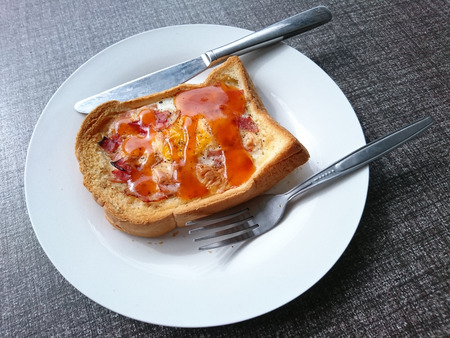Breakfast, fried egg ham and cheese topping on toast