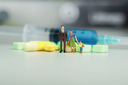 Miniature people - The family with Medicine pillsの写真素材