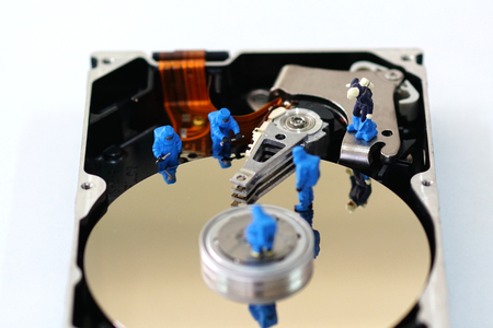 Miniature workers repair harddisk drive