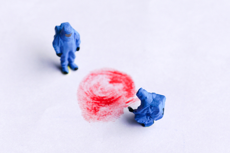 The concept of miniature crime scene investigator with red fingerprintの写真素材