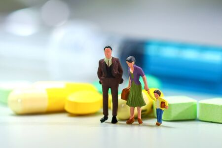 Miniature people - The family with Medicine pillsの写真素材