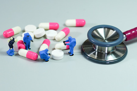 Miniature scientist at work with Medicine pillsの写真素材