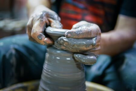 Potter At Work. Man potter making ceramic pot on the pottery wheelの写真素材