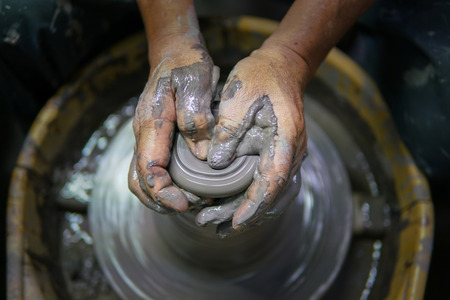 Potter At Work. Man potter making ceramic pot on the pottery wheelの写真素材