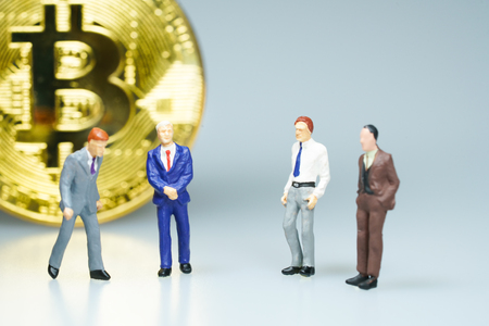 Miniature people : Businessman with golden coin. Business concept.の写真素材