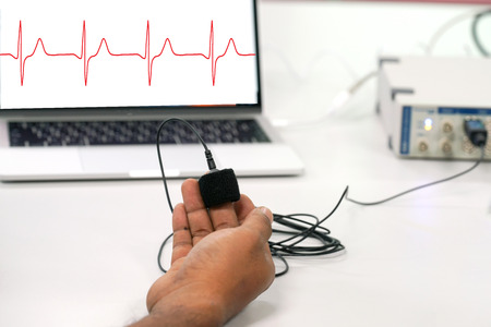 Finger pulse oximeter monitoring vital sign and heart rate, Medical concept