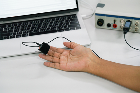 Finger pulse oximeter monitoring vital sign and heart rate, Medical concept