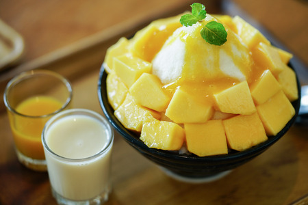 Korean shaved milk ice topped by fresh mango. Mango bingsu.の写真素材