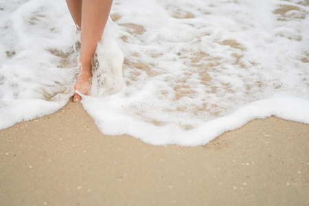 Legs of  walking on the beach, relaxing timeの写真素材