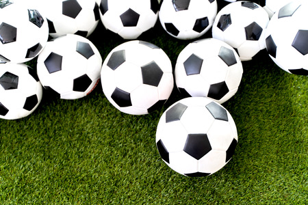 Football ball on the green grass field background.の写真素材