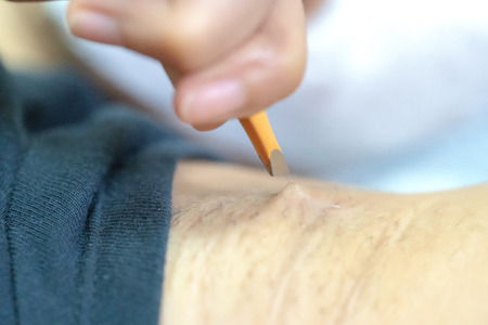 Close up hand of woman plucking armpit hair removal. Beauty  care.の写真素材