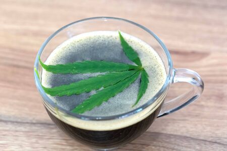 Black coffee with Cannabis(marijuana) leaves. Medical cannabis, Alternative medicine.の写真素材
