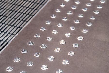Anti slip round metal buttons on the floor.の写真素材