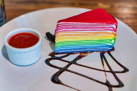 Delicious homemade rainbow layer cake on the plate.の写真素材