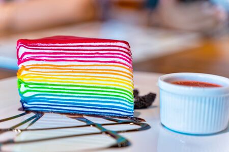 Delicious homemade rainbow layer cake on the plate.の写真素材