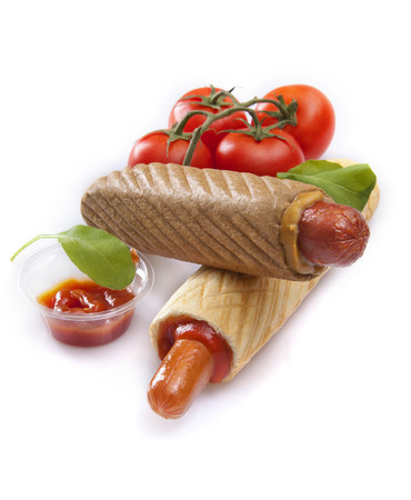 French hot dogs with ketchup and tomatoes on white backgroundの写真素材
