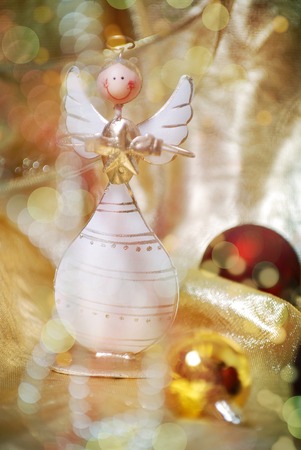 Christmas wooden angel with red and golden decorationの写真素材
