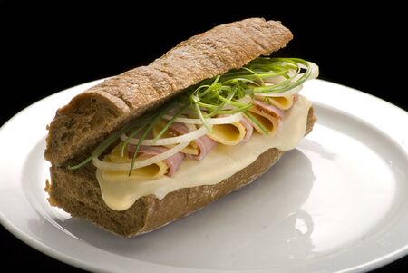 Traditional Italian sandwich with ham and cheese on a white plateの写真素材