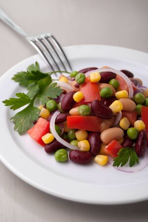 Closeup of healthy bean salad on a white plateの写真素材