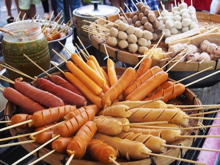 skewers meatballs and sausages on bamboo sticks, thailand traditional street foodの写真素材