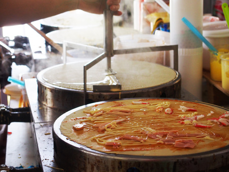 process of cooking pancake or dessert crepe on a hot plateの写真素材