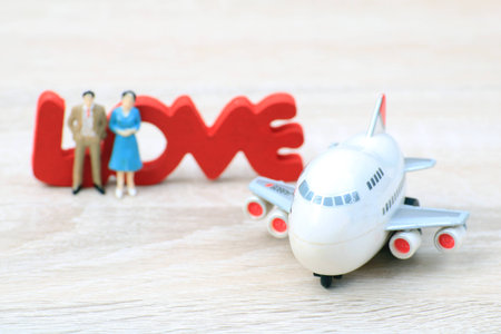 Miniature people love couple stand with plane for tour around world,Concept for those who succeed from saving and investing.の写真素材