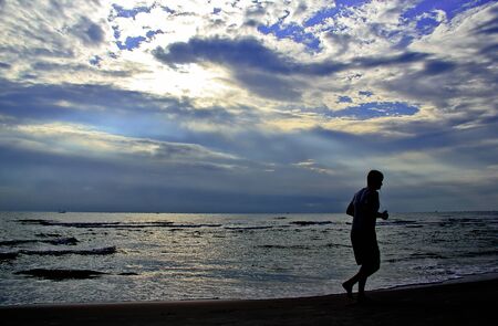 Man jogging on the beachの写真素材