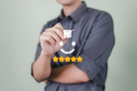 Customer service and Satisfaction concept, Businessmen touch the virtual screen on the happy Smiling face icon to give satisfaction in service. rating very impressed.の写真素材