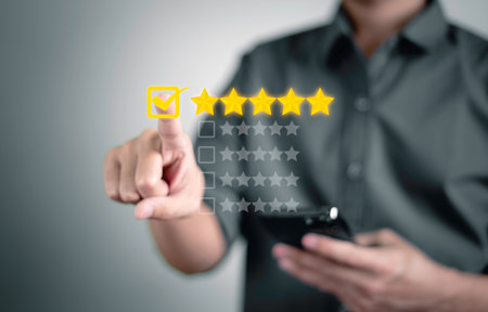 Customer service and Satisfaction concept, Businessmen touching the virtual screen and doing mark to five yellow stars to give satisfaction in service. rating very impressed.の写真素材
