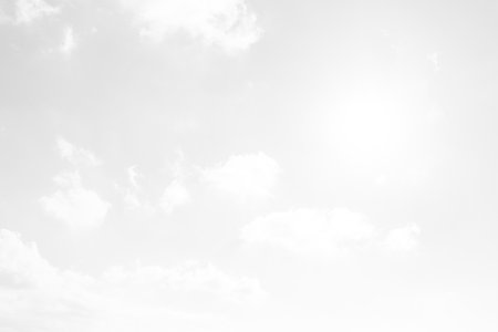 White fluffy clouds in the blue sky. Abstract background for design.の写真素材