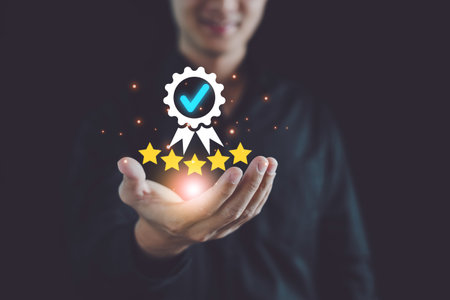 Quality Assurance and Good Service Concept, Man show High quality assurance icon on hand, Five stars, Certificate, Premium service assurance, Business excellence, Excellent service, High quality.の写真素材