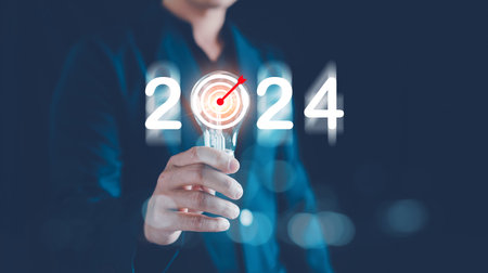 Business target and goals trends 2024, Analytical Businessman holding light bulb with planning...