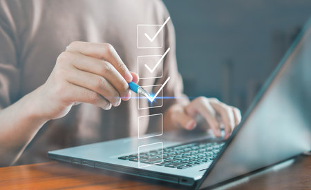 Evaluate performance checklist, questionnaire, Businessman using laptop doing online checklist survey, file out digital form checklist, take an assessment, business, quiz, online survey, online exam.の写真素材