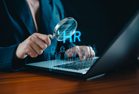 Human Resource Management concept. HRM. Businessman holding magnifier for searching to human icons for human development and recruitment concept. HR management. Cluster, consulting, business, people.の写真素材