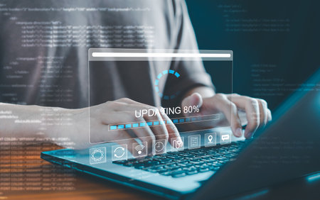 Software update or operating system upgrade: A progress bar shows the installation of an app patch on a laptop, representing digital updates to software applications and hardware upgrades.の写真素材